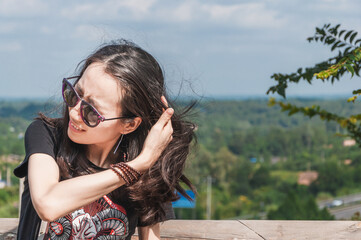 Oriental women traveling outdoors in hot summer