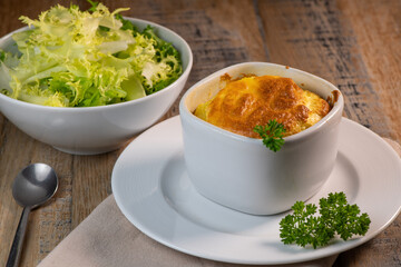 Cheese egg souffle on rustic cloth on a wooden background