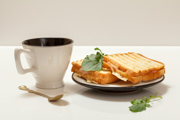 Homemade grilled cheese sandwiches for breakfast with cup of coffee.