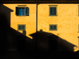 Shadow of House on facade of yellow building