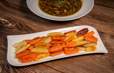 Chicken Hunter recipe with glazed root vegetables, carrot, turnip with its mushroom sauce deglazed in white wine and wet with the chicken stock