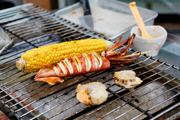 Japanese tasty street and fast food: grilled squid, corn and shellfish.