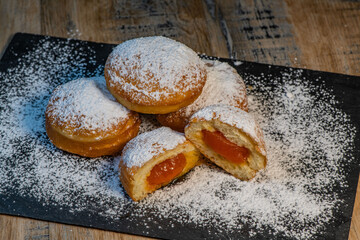 Freshly cooked Apricot jam doughnuts, referred to as jelly doughnuts, donuts in the US