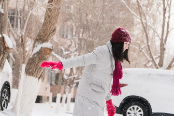 Oriental girls playing in the snow in winter