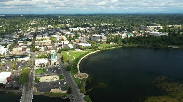 4K cinematic aerial drone pan footage of the Olympia Yacht Club near the Washington State Capitol Building and Campus, Capitol Lake, with a panoramic view of Historic District in Olympia, Washington