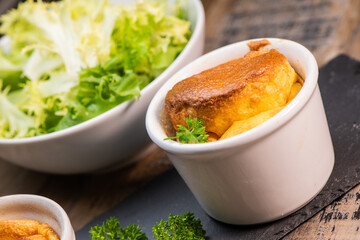 Cheese egg souffle on rustic cloth on a wooden background