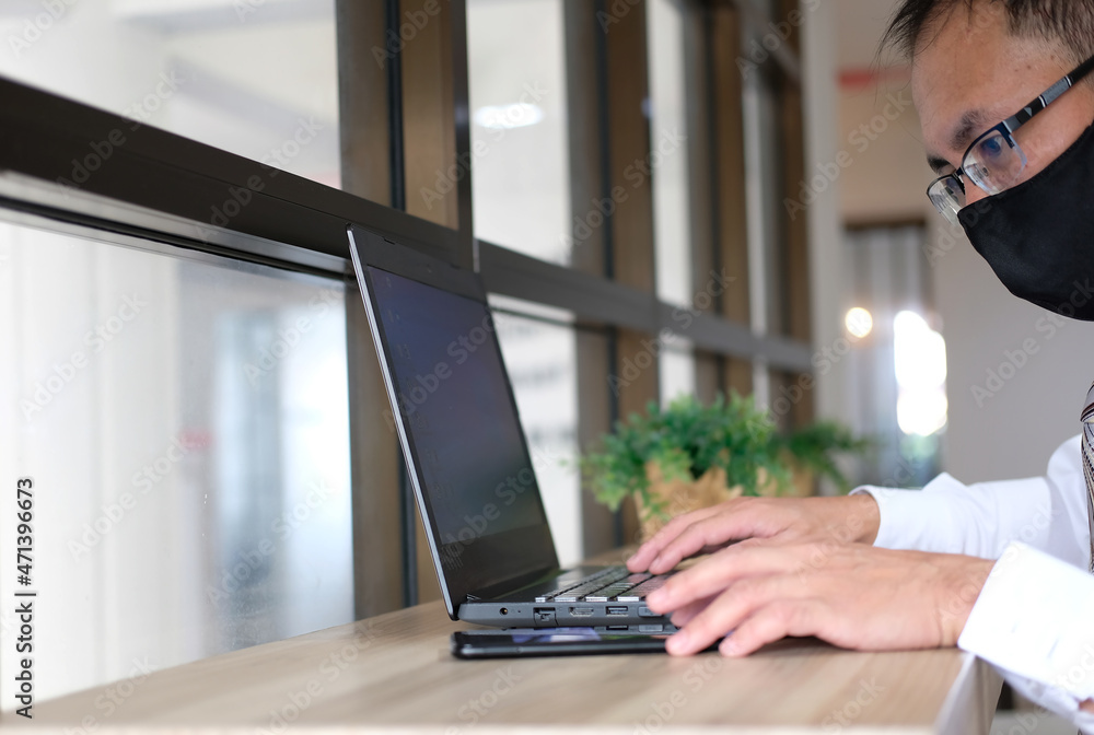 Poster man is working on a computer and email marketing concept, sending an e-mail or newsletter, and worki