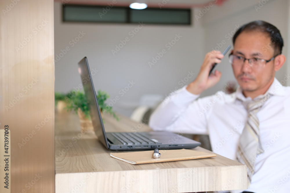 Poster concept of unrecognisable businessman using a laptop while working remotely, hands working on modern