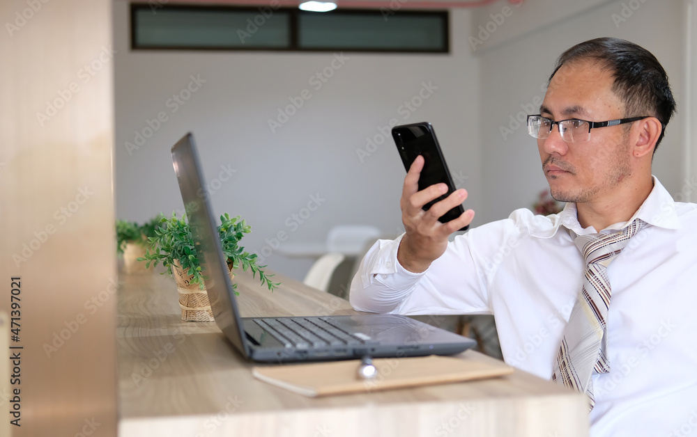 Poster concept of unrecognisable businessman using a laptop while working remotely, hands working on modern