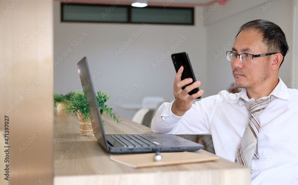 Aufkleber concept of a businessman using a smartphone on a desk and technology