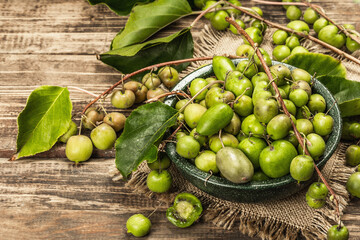 Harvest of ripe Actinidia arguta kiwi in a ceramic bowl