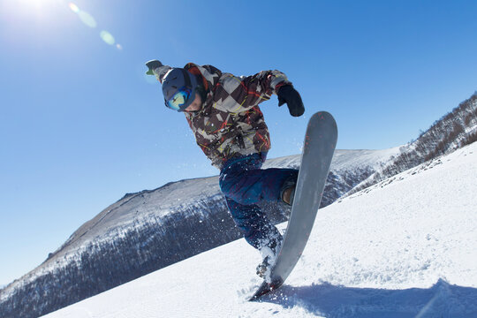 a male snowboarder jumping in the air