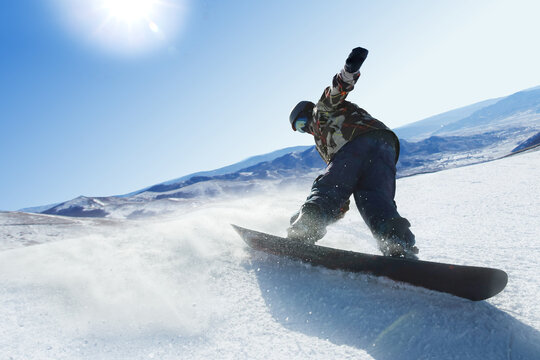 a male snowboarder ski on the snow
