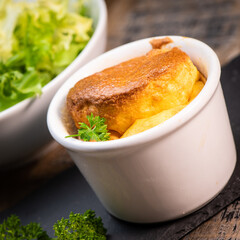 Cheese egg souffle on rustic cloth on a wooden background