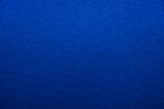 Navy blue abstract background. Gradient. Silk fabric surface texture. Elegant background with copy space for design.