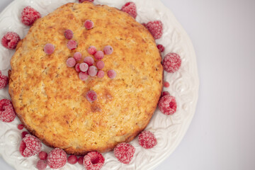 Banana pie with berries on a white background
