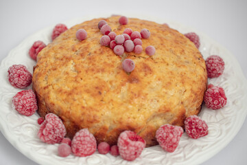 Banana pie with berries on a white background