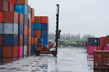 container forklift moving containers working in the rain
