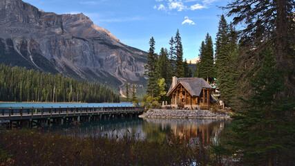 Beautiful view of Emerald Lake in Yoho National Park, British Columbia, Canada in the afternoon light with wooden lodge building and bridge in autumn.