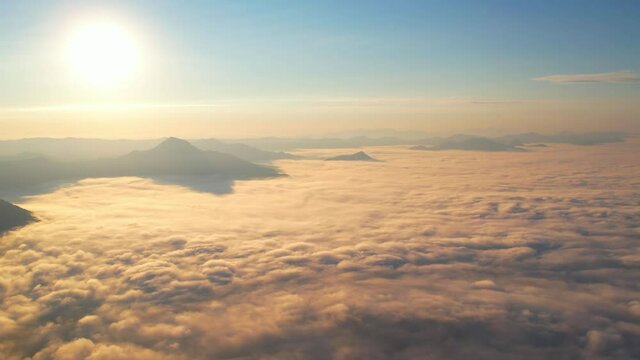4K Aerial video Beautiful sunrise above dense clouds and fog in the morning, Cinematic drone shot.
