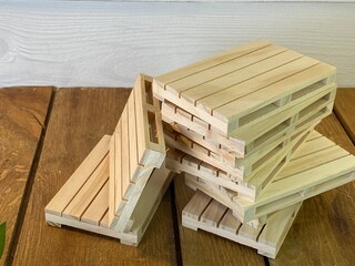 There are wooden pallets on the oak table - obrazy, fototapety, plakaty