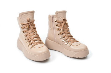 Womens beige leather boots with zip and lacing, photographed against a white background.