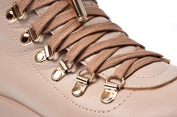 Womens beige leather boots with zip and lacing, photographed against a white background.