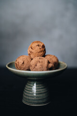 Pieces of chocolate with sweets truffle on a dark background.