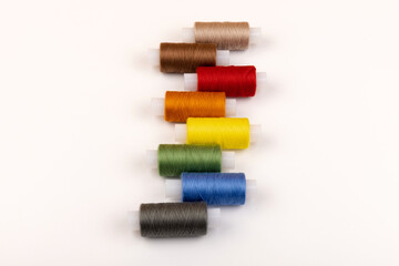 Color sewing threads isolated on white background. Different colors.Bright bobbin thread.