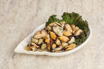 Tasty marinated mussels in the bowl