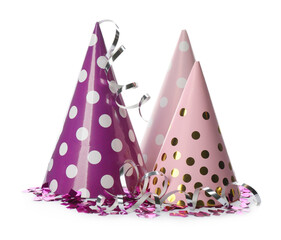 Colorful party hats and confetti on white background