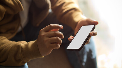 Businessman, male freelancer using a smartphone. blank screen mockup.