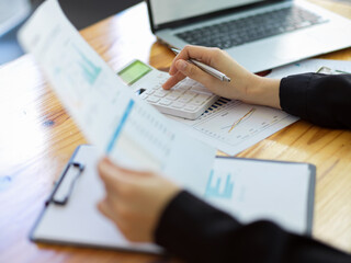 Cropped image of Female accountant calculating expense