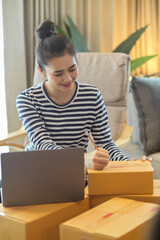 Female online store owner pack a shipping boxes for delivery.