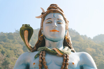 A fragment of a religious sculpture in Rishikesh, India. God Shiva on the banks of the Ganges river...