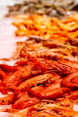Seafood store, prawns on ice with out of focus background, selective focus.
