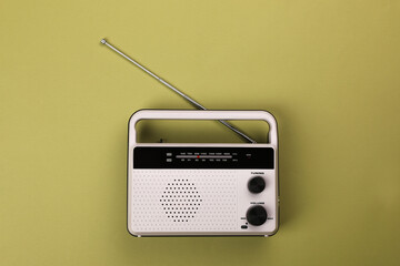 Retro radio receiver on light green background, top view
