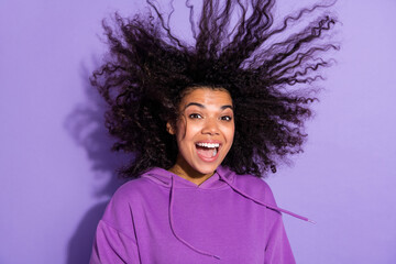 Photo of astonished carefree person flying wavy hairdo open mouth look camera isolated on purple...