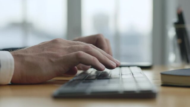 Hands Adult Businessman Busy Working on Computer Keyboard Macro Shot. Close up Man Sit at Office Desk and Working Online with PC Software Apps Technology. Person Typing on Keypad Business Letter