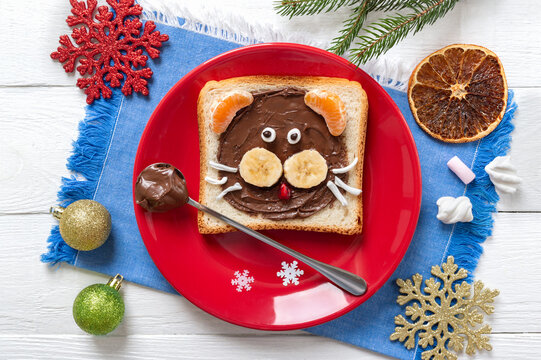 Tiger Head Sandwich With Chocolate, Banana, Tangerine And Marshmallow On A Plate On A Blue Napkin. Festive Breakfast For Kids. Top View.