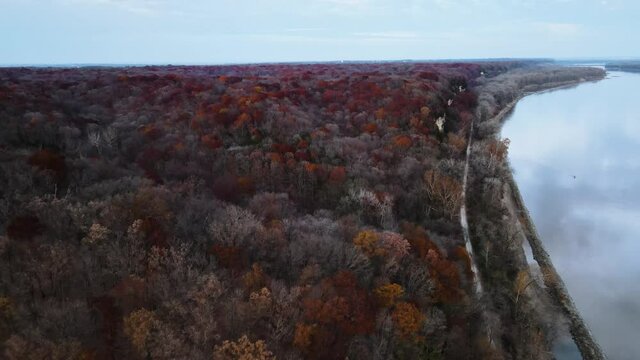 Drone Shot next to the Missouri River. Weldon Spring Lewis and Clark Hiking Trail (Katy Trail). During the autumn season change, red and yellow trees.