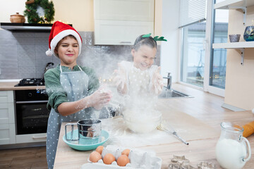 Children are baking Christmas cookies and having fun.