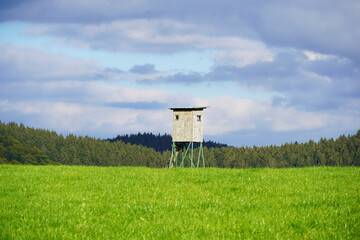 Landscape in the Sauerland with green fields and a hunting seat
