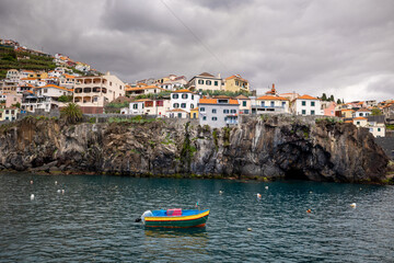 A small port with colorful boats in Madeira.