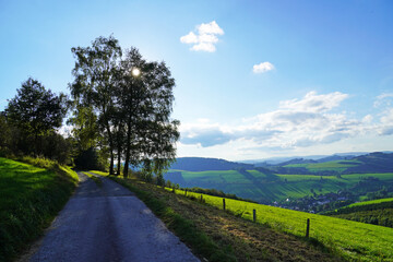 Fototapeta na wymiar Landscape in the Sauerland near Oberhenneborn. Panoramic view of the green nature with hills and forests. 