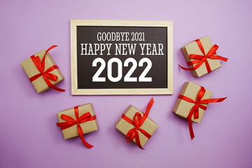 Happy New Year 2022 typography text with gift box on purple background
