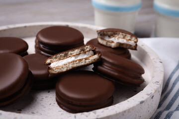 Tasty choco pies in plate, closeup view