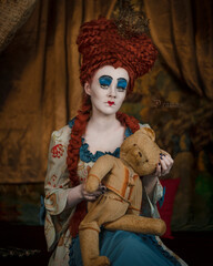 Cosplay Queen of Hearts with a bear based on the book Alice in Wonderland