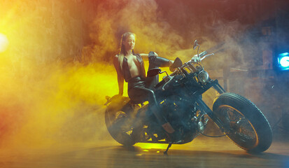 Young  woman sitting on motorcycle