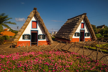 Fototapeta na wymiar Santana traditional houses in Madeira during hot spring with pretty sky and colours